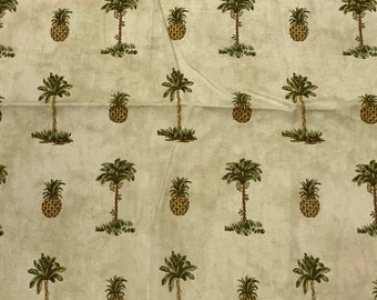 May include: A beige fabric with a repeating pattern of green palm trees and brown pineapples.