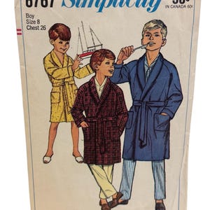 May include: Vintage Simplicity pattern 6767 for boys' robes and pajamas. The illustration shows three boys in different robes, including a yellow, a plaid, and a blue robe. The pattern includes size 8 with a 26-inch chest.