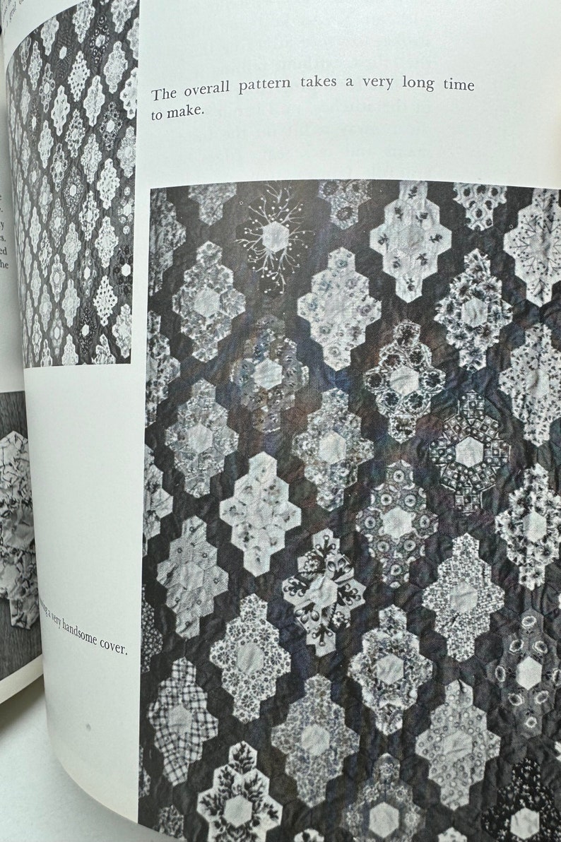 May include: A black and white quilt with a geometric pattern. The quilt is made up of many small squares and triangles, and it has a very intricate design. The overall pattern takes a very long time to make.