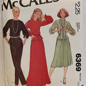 May include: A sewing pattern for a dress with three different styles. The pattern is from McCall's and is for a miss size medium. The dress can be made in red, green, or black.