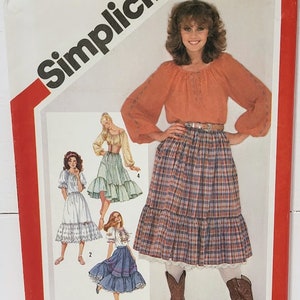 May include: Simplicity sewing pattern number 5283 for a skirt. The pattern includes four different skirt styles, including a plaid skirt, a white skirt with lace trim, a green skirt with lace trim, and a blue skirt with lace trim. The pattern includes instructions for embroidery.