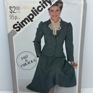 May include: Simplicity sewing pattern number 5606 for a skirt and jacket set. The pattern is for size 12 miss. The pattern shows a woman wearing a gray skirt and jacket set. The pattern is labeled "Fast & Fabulous".