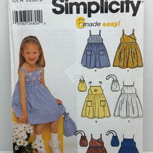 May include: Simplicity sewing pattern 9647, size A 3, 4, 5, 6, 7, 8, made easy!  The pattern includes six different dress designs for girls.  The dresses are all sleeveless and have a variety of styles, including a striped dress, a floral dress, a yellow dress, a white dress, a red and blue floral dress, and a blue dress.