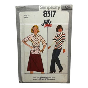 May include: A Simplicity 8317 Jiffy Plus sewing pattern envelope for size 12 miss. The front shows two illustrations: one of a white blouse with red paisley print and a maroon skirt, and another of a chevron-striped top with dark blue pants.