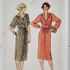 May include: Vintage Vogue sewing pattern for a dress, size 12. The pattern shows two models wearing different versions of the dress, one in a striped fabric and the other in a solid color. The pattern is labeled "Vogue Patterns" and has a price of $3.50.