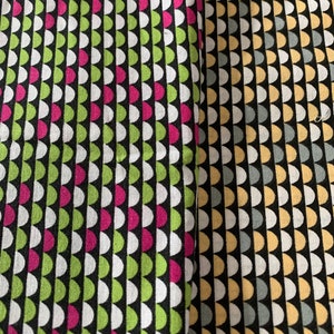 May include: Two fabric swatches with a repeating semi-circle pattern. One swatch features green, pink, and white semi-circles on a black background. The other has yellow, grey, and white semi-circles on black.