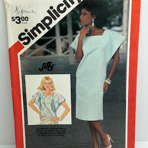 May include: Simplicity sewing pattern number 6324 for a dress with a square neckline and short sleeves. The pattern is for sizes 12, 14, and 16. The pattern is printed on a white background with red and black text.