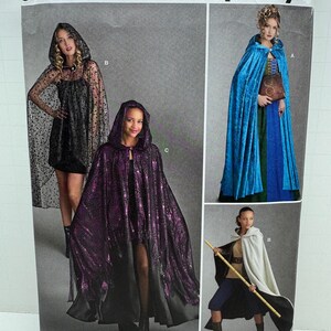 May include: Simplicity sewing pattern number 8721 for a hooded cape. The pattern includes three different styles: a black cape with stars, a purple cape with sequins, and a white cape. The pattern is for one size.