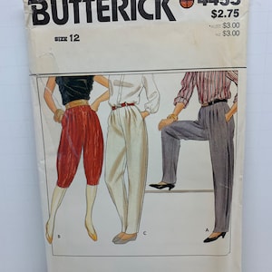 May include: A vintage sewing pattern for trousers, size 12, from Butterick, pattern number 4455. The pattern shows three different styles of trousers, one with a striped top, one with a white top, and one with a black top.
