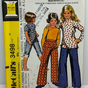 Puede incluir: Un patrón de costura vintage para blusas y pantalones para niños. El patrón es para McCall's 3498 y es para tejidos de punto elásticos no unidos. El patrón incluye instrucciones para blusas de manga larga y pantalones de pierna ancha.
