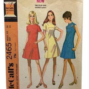 May include: Vintage McCall's sewing pattern featuring three dresses in different colors: red, yellow, and blue. The pattern includes a two-color guide and is for Misses' size 14, with a 36-inch bust. The pattern is labeled "New" and "Step-by-Step Pattern."