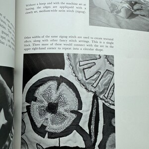 May include: A close-up of a black and white fabric design with a zigzag stitch. The design features a flower shape with a smaller circle in the center. The text "Without a hoop and with the machine set at basting, the edges are appliqu&eacute;d with a closely set, medium-wide satin stitch (zigzag). Other widths of the same zigzag stitch are used to create textural effects, along with other fancy stitch settings. This is a single block. Three more of these would connect with the arc in the upper right-hand corner to repeat into a circular shape." is visible in the image.