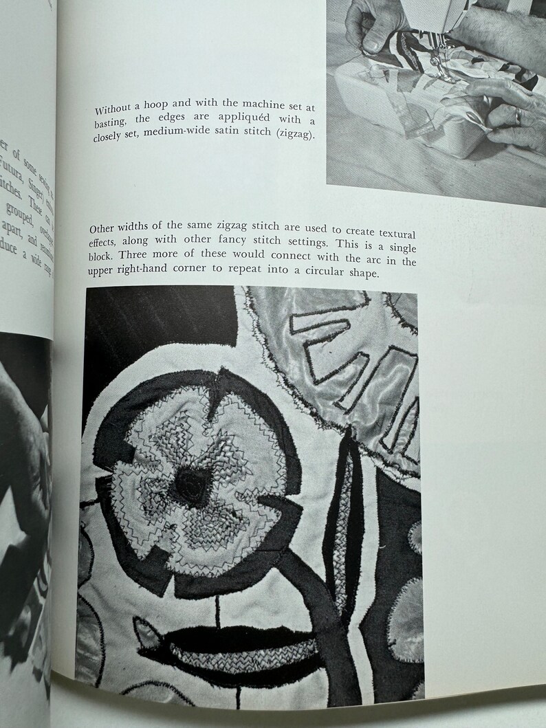 May include: A close-up of a black and white fabric design with a zigzag stitch. The design features a flower shape with a smaller circle in the center. The text "Without a hoop and with the machine set at basting, the edges are appliqu&eacute;d with a closely set, medium-wide satin stitch (zigzag). Other widths of the same zigzag stitch are used to create textural effects, along with other fancy stitch settings. This is a single block. Three more of these would connect with the arc in the upper right-hand corner to repeat into a circular shape." is visible in the image.