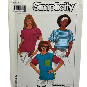 Puede incluir: Patrón de costura Simplicity para camisetas Surf Club, talla XL. El patrón presenta ilustraciones de tres diseños de camisetas: una camiseta rosa lisa, una camiseta a rayas azules y blancas y una camiseta con bloques de color con un bolsillo verde.