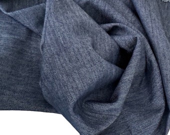 May include: A close-up of a dark blue denim fabric, showing the texture and weave of the material.