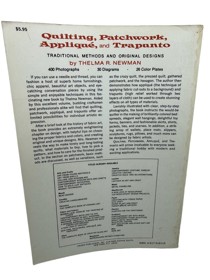 May include: Book cover with a brown background and white text. The title is "Quilting, Patchwork, Appliqu&eacute;, and Trapunto: Traditional Methods and Original Designs" by Thelma R. Newman. The book features 400 photographs, 30 diagrams, and 26 color plates.