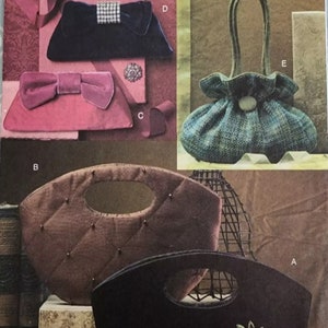 May include: Image of a Vogue Accessories pattern featuring various handbag designs. The handbags include a black clutch with a floral embellishment, a quilted brown bag, and a pink clutch with a bow. The pattern number is V8174.