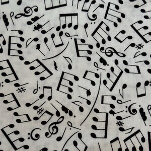 Puede incluir: Tela blanca con un patrón de notas musicales negras. Las notas incluyen claves de sol, negras, corcheas y redondas.