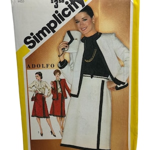 May include: Simplicity sewing pattern number 5193 for a skirt and jacket. The pattern is for size 10 miss and costs $3.50. The pattern shows a white jacket with black trim and a white skirt with black trim. The model is wearing a black top with a gold chain necklace.