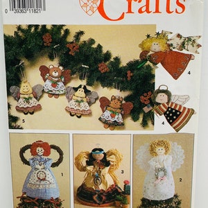 May include: A Simplicity Crafts sewing pattern for making five different angel ornaments. The pattern includes instructions for making a red angel, a blue angel, a white angel, a brown angel, and a Native American angel. The pattern also includes instructions for making a wreath and a tree topper.