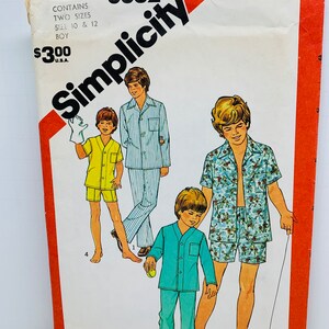May include: Simplicity sewing pattern number 6382 for boys' pyjamas. The pattern includes two sizes, 10 and 12. The pattern shows three boys wearing different styles of pyjamas, including a blue and white striped pyjama set, a green pyjama set, and a patterned pyjama set.