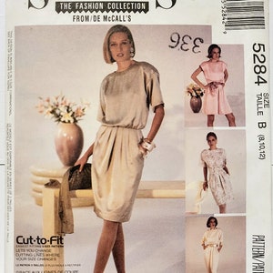 May include: Sew News fashion collection pattern. The front of the pattern envelope features a woman in a beige dress. Additional images show other dress styles. Text includes "Cut-to-Fit" and "Easy McCall's".