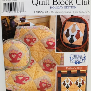 May include: A Simplicity Quilt Block Club pattern booklet with a holiday edition theme. The cover features two quilt blocks, one with a teacup design and the other with a tie design. The text on the cover reads "My Mother's Teacup & My Father's Tie".