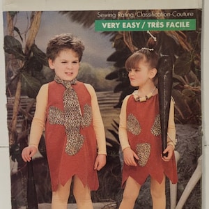May include: A vintage sewing pattern for a child's costume. The pattern is for a caveman costume and includes a dress and a club. The pattern is labelled "Butterick 5806" and is rated "Very Easy".