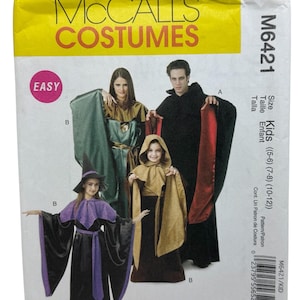 Op de afbeelding: McCall's Costumes patroon M6421. De verpakking toont illustraties van kostuums, waaronder een heks en een figuur met capuchon. De kostuums zijn in zwart, paars, groen en goud. De verpakking is gemarkeerd met "Easy" en bevat maat informatie voor kinderen.