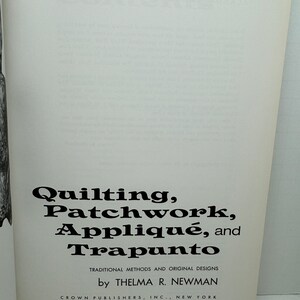 May include: Book cover with the title "Quilting, Patchwork, Appliqu&eacute;, and Trapunto" in black text. The subtitle is "Traditional Methods and Original Designs" in smaller black text. The author is "by Thelma R. Newman" and the publisher is "Crown Publishers, Inc., New York".