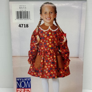 May include: A sewing pattern for a girl's dress with a red, yellow, and blue print of chickens. The pattern is for sizes 4-5-6 and is from the see & sew brand. The pattern is titled "YES! IT'S easy".