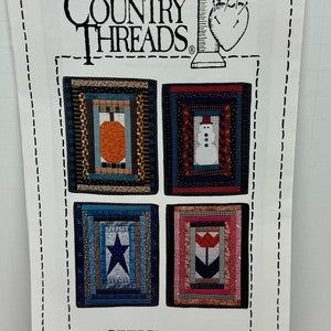 May include: A Country Threads quilting pattern titled "Seasons #419". The pattern features four different quilt blocks, each depicting a different season: fall, winter, spring, and summer. The blocks are surrounded by a white border.