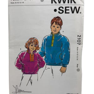 May include: A vintage Kwik Sew sewing pattern packet, featuring illustrations of children's sweatshirts. The packet is white with the text "KWIK SEW" and "Pattern 2107". Sizes 8-10-12-14 are listed. The design is by Kerstin Martensson.