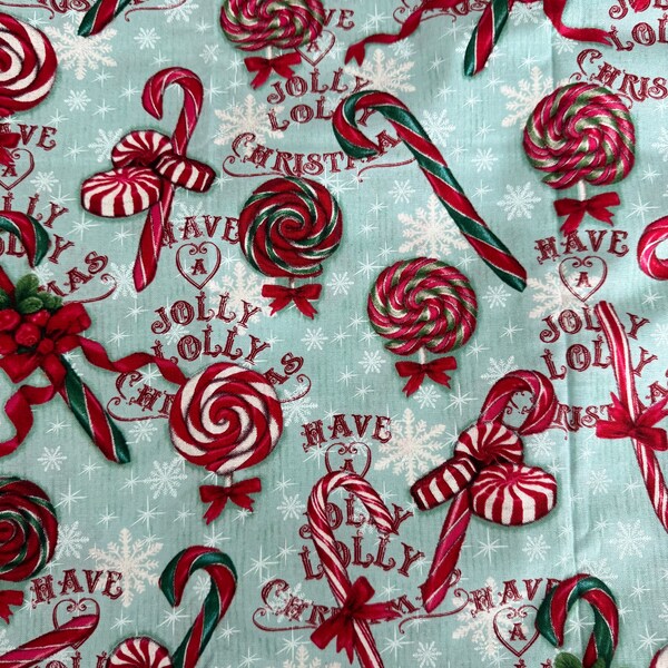 Tener un Jolly Lolly Tela navideña Algodón Copos de nieve Bastones de caramelo Piruletas Palabras Manzana salvaje Azul Rojo David Textiles OOP 45 x 36