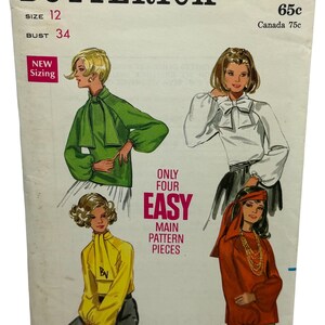 May include: Vintage sewing pattern envelope for a blouse with a bow. The pattern is from Butterick and is number 5450. The envelope shows three different styles of blouses with long sleeves and a high neck. The pattern is for size 12 and bust 34. The text on the envelope says "Only Four Easy Main Pattern Pieces".
