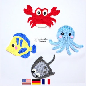 May include: Crocheted sea creature set featuring a red crab, yellow and blue fish, blue octopus, and gray stingray. The handmade aquatic animals have black and white eyes and are displayed on a white background. The text "Little Bamboo Handmade" is also visible.