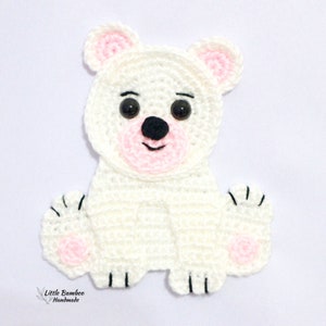 May include: White crocheted polar bear applique with black eyes, black nose, and pink accents on the ears, mouth, and paws.