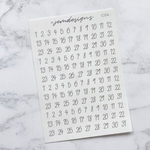 May include: A sheet of white paper with a set of numbers 1 through 31 repeated eight times. The numbers are written in a handwritten font. The text "jemdesigns" and "C134" are printed in the top right corner of the sheet.