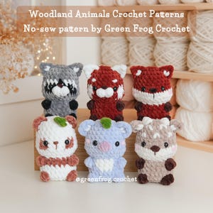 May include: A collection of six handmade crochet woodland animal patterns. The animals include a raccoon, red panda, fox, panda, koala, and deer. Each animal is made with soft yarn in various colors and features detailed facial features.