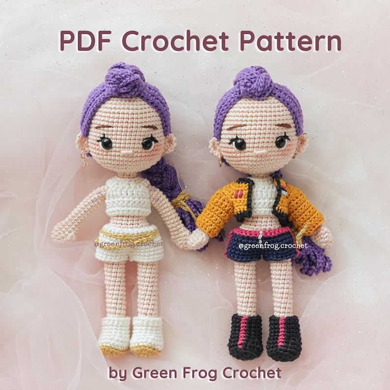 May include: Two handmade crochet dolls with purple hair, wearing different outfits. One doll is in a white crop top and shorts, the other in a yellow jacket and shorts. The text "PDF Crochet Pattern" and "by Green Frog Crochet" are visible.