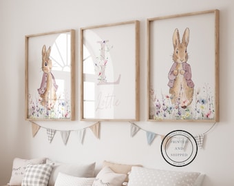 May include: Three framed prints featuring a watercolor illustration of a bunny rabbit with floral accents. The middle print features the letter "L" with the name "Lottie" written below it.