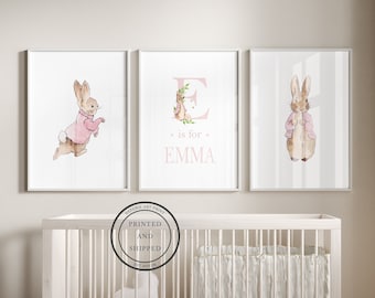 May include: Three framed prints featuring a watercolor illustration of a bunny rabbit wearing a pink jacket. The middle print features the letter E in pink with floral accents and the text "is for EMMA".