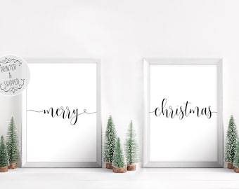 May include: Two white framed prints with black calligraphy. The left print says "merry" with a small heart symbol. The right print says "christmas".