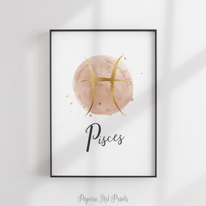 May include: A watercolor print of the Pisces zodiac sign in gold on a blush pink background. The word "Pisces" is written in black below the sign.