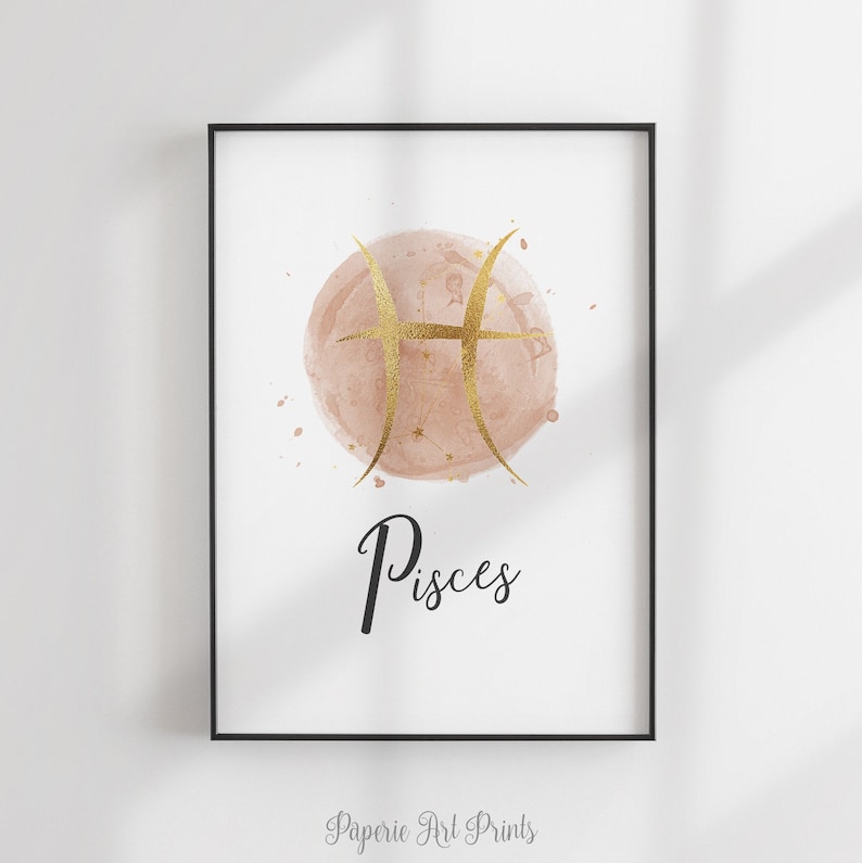 May include: A watercolor print of the Pisces zodiac sign in gold on a blush pink background. The word "Pisces" is written in black below the sign.