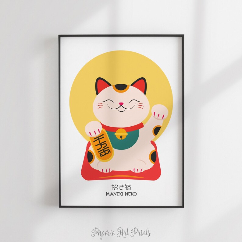 May include: A white and red Maneki Neko, or lucky cat, with a raised paw, sitting on a red cushion. The cat is holding a gold sign with the Japanese characters for "good fortune" written on it. The cat is in front of a yellow circle.