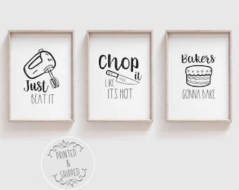 May include: Three black and white kitchen-themed prints with text and illustrations. The first print says "Just Beat It" with an illustration of a stand mixer. The second print says "Chop It Like It's Hot" with an illustration of a knife. The third print says "Bakers Gonna Bake" with an illustration of a cake.