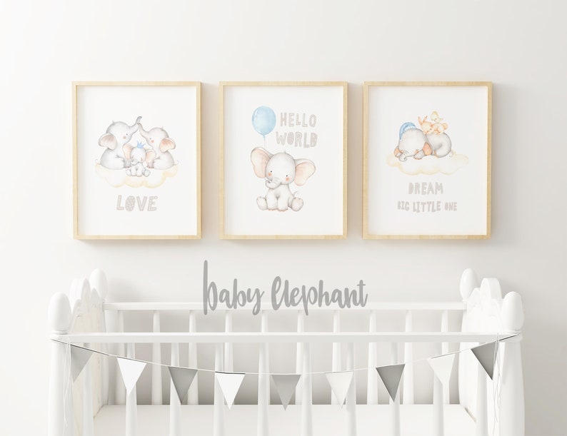 May include: Three framed prints with watercolor illustrations of baby elephants. The first print features a family of elephants with the word "LOVE" below. The second print features a single elephant with a blue balloon and the words "HELLO WORLD". The third print features two elephants sleeping on a cloud with the words "DREAM BIG LITTLE ONE".
