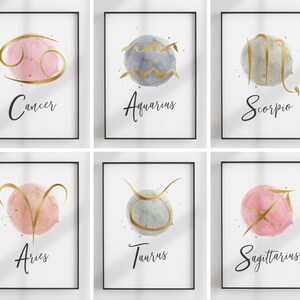 May include: Set of six watercolor zodiac signs with gold foil accents. Each sign is on a white background with the name of the sign written below. The signs are: Cancer, Aquarius, Scorpio, Aries, Taurus, and Sagittarius.