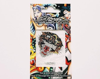 May include: Ed Hardy by Christian Audigier Icing peel and stick crystal decal featuring a tiger face with rhinestones. The decal is on a white background with a colorful border.